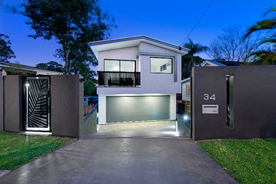 This is an example of a contemporary two-storey white exterior in Brisbane with mixed siding.