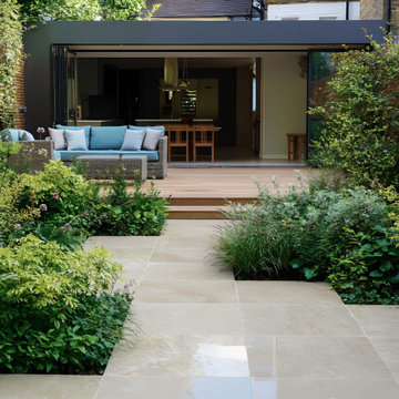 Small Contemporary Garden with Limestone Paving and Composite Decking