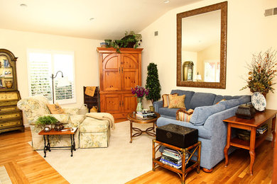 This is an example of a large traditional formal enclosed living room in San Diego with yellow walls, dark hardwood floors, no fireplace, no tv and brown floor.