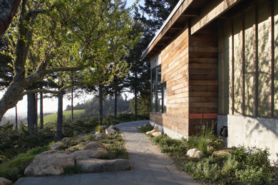 Example of a large trendy two-story mixed siding house exterior design in San Francisco with a shed roof and a green roof