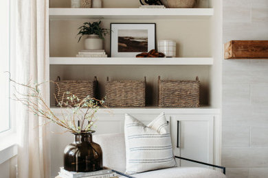 Foto de sala de estar abierta costera grande con suelo de madera clara, marco de chimenea de baldosas y/o azulejos, televisor colgado en la pared y suelo beige