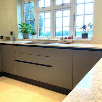 Taupe handleless kitchen with beautiful views