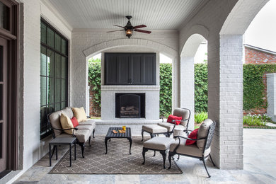 Mid-sized country backyard patio in New Orleans with a roof extension.