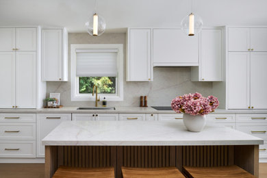 Inspiration for a mid-sized transitional kitchen remodel in Toronto with an undermount sink, shaker cabinets, white cabinets, quartz countertops, multicolored backsplash, quartz backsplash, an island and multicolored countertops