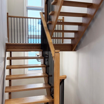 Modern White Oak Open Riser Staircase with Black Metal Balusters