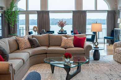 Inspiration for a large contemporary open concept medium tone wood floor, brown floor and vaulted ceiling living room remodel in Nashville with a corner fireplace, a wood fireplace surround and a corner tv