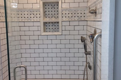 Bathroom - farmhouse master white tile and subway tile porcelain tile and gray floor bathroom idea in Other with raised-panel cabinets, black cabinets, a two-piece toilet, gray walls, an undermount sink, quartz countertops and a hinged shower door
