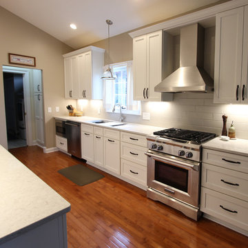 White Kitchen with Quartz Countertop, Galley Workstation and Large Subway Tile