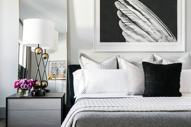 Example of a large trendy master medium tone wood floor and brown floor bedroom design in Houston with white walls
