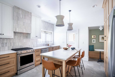 Mid-sized trendy ceramic tile and gray floor kitchen photo in Portland with an undermount sink, shaker cabinets, light wood cabinets, quartzite countertops, gray backsplash, ceramic backsplash, stainless steel appliances, an island and multicolored countertops