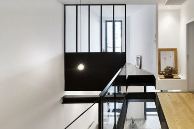 This is an example of a mid-sized contemporary hallway in Marseille with white walls.