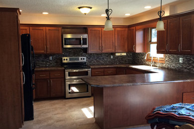 Kitchen photo in Other with a double-bowl sink, flat-panel cabinets, medium tone wood cabinets, laminate countertops, multicolored backsplash, glass tile backsplash and stainless steel appliances