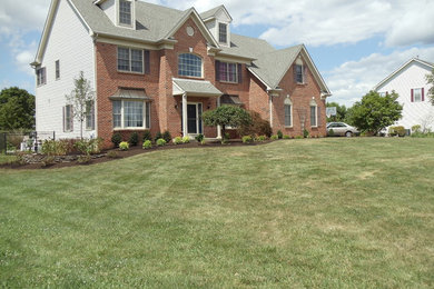 Large craftsman three-story brick exterior home idea in Philadelphia with a shingle roof