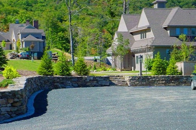 This is an example of a large traditional front yard full sun driveway in Burlington with gravel.