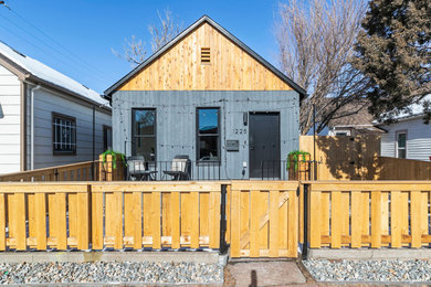 Small trendy one-story wood exterior home photo in Denver with a shingle roof