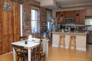 Mid-sized southwest u-shaped light wood floor eat-in kitchen photo in Other with recessed-panel cabinets, medium tone wood cabinets, quartzite countertops, stainless steel appliances and an island
