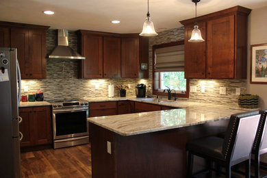 Kitchen - mid-sized traditional u-shaped medium tone wood floor and brown floor kitchen idea in Other with an undermount sink, shaker cabinets, medium tone wood cabinets, quartz countertops, multicolored backsplash, matchstick tile backsplash, stainless steel appliances and a peninsula