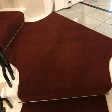 Stair rods and dark red carpe runner
