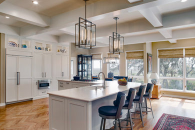 Example of a large transitional medium tone wood floor and coffered ceiling open concept kitchen design in Atlanta with a single-bowl sink, shaker cabinets, white cabinets, quartz countertops, stainless steel appliances, an island and white countertops