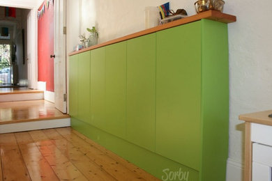 Photo of a small eclectic single-wall eat-in kitchen in Sydney with flat-panel cabinets, green cabinets and wood benchtops.