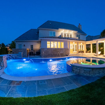 Naperville, IL freeform swimming pool with hot tub, large sunshelf, glass tile
