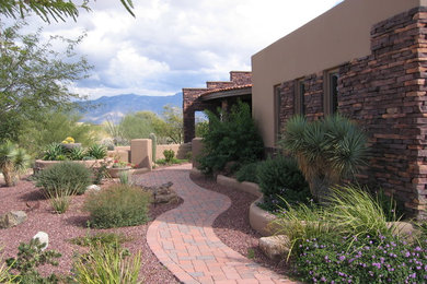 Design ideas for a large contemporary side yard partial sun xeriscape for spring in Phoenix with a garden path and gravel.