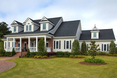 Large traditional two-storey beige exterior in Other with wood siding.