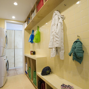 Contemporary utility room in Charlotte with a stacked washer and dryer.