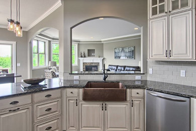 Mid-sized elegant dark wood floor open concept kitchen photo in Other with a farmhouse sink, raised-panel cabinets, white cabinets, quartz countertops, beige backsplash, ceramic backsplash, stainless steel appliances and a peninsula