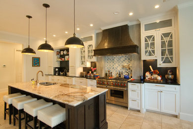 Inspiration for a large transitional u-shaped travertine floor eat-in kitchen remodel in Houston with a double-bowl sink, glass-front cabinets, white cabinets, black backsplash, stone slab backsplash, stainless steel appliances, an island and beige countertops