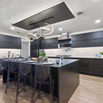 Custom kitchen with dark cabinetry and integrated range hood