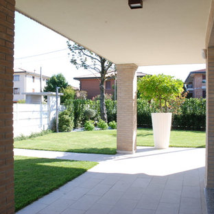 Design ideas for a mid-sized modern front yard partial sun driveway for fall in Other with with path.