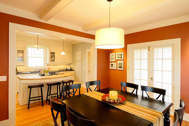 Inspiration for a mid-sized craftsman galley light wood floor eat-in kitchen remodel in Seattle with an undermount sink, beaded inset cabinets, white cabinets, soapstone countertops, white backsplash, ceramic backsplash, stainless steel appliances and an island