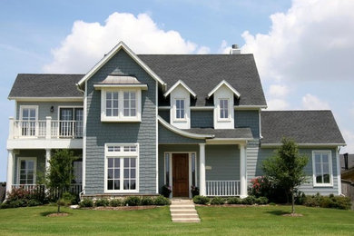 Example of a large classic blue two-story wood exterior home design in Other with a shingle roof