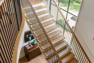 Example of a large transitional wooden floating mixed material railing staircase design in Charlotte