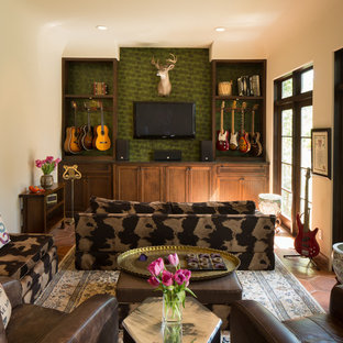 Mittelgroßes Mediterranes Musikzimmer ohne Kamin mit grüner Wandfarbe, Terrakottaboden und Wand-TV in Houston