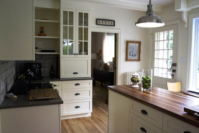 Kitchen pantry - mid-sized transitional u-shaped light wood floor kitchen pantry idea in Montreal with a drop-in sink, shaker cabinets, white cabinets, quartzite countertops, gray backsplash, cement tile backsplash, stainless steel appliances and an island