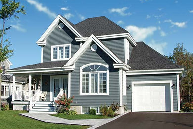 Inspiration for a mid-sized country two-storey blue exterior in Montreal with vinyl siding.