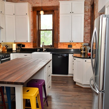 Bourbon, IN. Haas Signature Collection. Farmhouse Kitchen with Exposed Brick