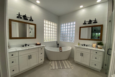 Bathroom - country master porcelain tile, gray floor, single-sink and shiplap wall bathroom idea in Miami with flat-panel cabinets, white cabinets, marble countertops, white countertops and a freestanding vanity