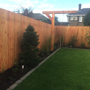 Hardwood fence and artificial lawn