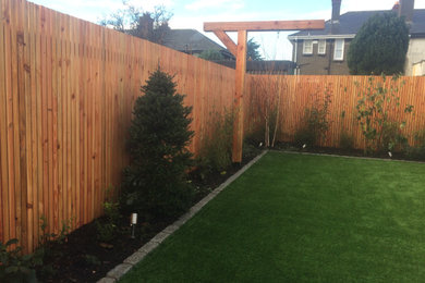 Hardwood fence and artificial lawn