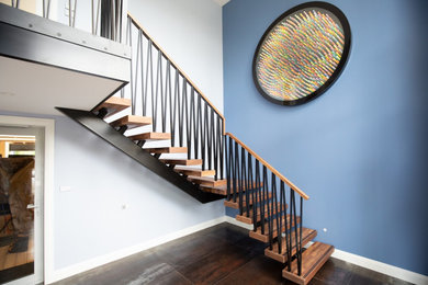 Diseño de escalera suspendida contemporánea de tamaño medio sin contrahuella con escalones de madera y barandilla de metal