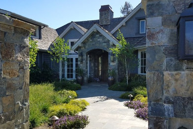 Inspiration for a large traditional two-storey grey house exterior in San Francisco with stone veneer and a mixed roof.