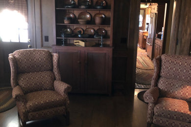 Large elegant enclosed medium tone wood floor living room photo in Omaha