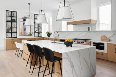 Inspiration for a contemporary light wood floor open concept kitchen remodel in Chicago with flat-panel cabinets, light wood cabinets, quartz countertops, white backsplash, quartz backsplash, an island and white countertops