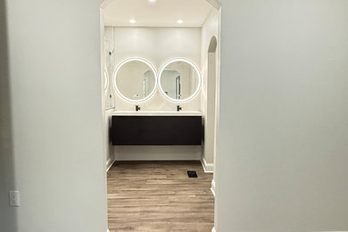 Example of a mid-century modern master gray tile and ceramic tile vinyl floor, brown floor and double-sink wet room design in DC Metro with flat-panel cabinets, black cabinets, a bidet, beige walls, an undermount sink, quartz countertops, a hinged shower door, white countertops and a floating vanity