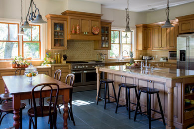 Example of a large transitional slate floor and green floor kitchen design in New York with an undermount sink, granite countertops, ceramic backsplash, stainless steel appliances and an island