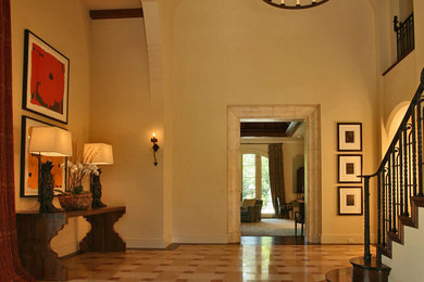 Photo of a large mediterranean foyer in San Francisco with beige walls and marble floors.