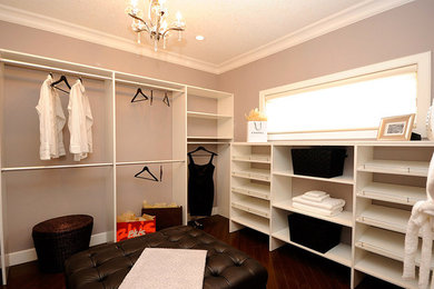 Large trendy women's dark wood floor walk-in closet photo in Edmonton with open cabinets and white cabinets